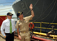 US Navy 090815-N-2147L-001 Cmdr. Curt Jones, right, commanding officer of the San Antonio-class amphibious transport dock ship Pre-Commissioning Unit (PCU) New York (LPD 21), briefs New York Jets owner Woody Johnson before givi.jpg