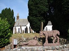pierre tombale représentant un vieillard et son âne