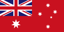 Fond rouge avec drapeau britannique en haut à gauche, la croix du sud à droite et l’étoile de la fédération en bas à gauche