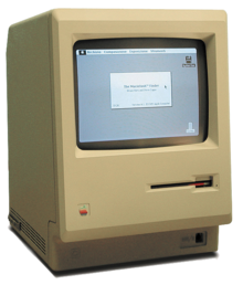 Un ordinateur beige en forme de pavé vertical, affichant quelques icônes.