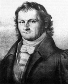 Portrait de Schneider de trois-quart face dessiné au crayon. Il a l'air résolu et a des cheveux longs.