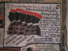 Graffiti sur les murs de la prison : cinq étudiants sont représentés par des silhouettes noires avec col blanc et casquette rouge.
