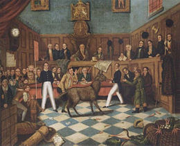 Tribunal où siègent ses membres. Au centre un âne, entouré de quatre personnages, dont un fait un pied de nez à l'âne.