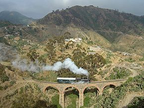 Sur les chemins de fer érythréens, actuellement seulement exploités entre Massaoua et Asmara, une locomotive de la série 440 circule sur la section montagneuse entre Arbaroba et Asmara, au niveau de la « porte du Diable »