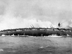 The sinking SMS Blücher rolls over onto her side.